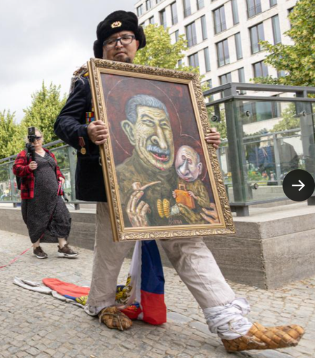 Skrepetskiy showing a painting where Stalin feeds baby Putin